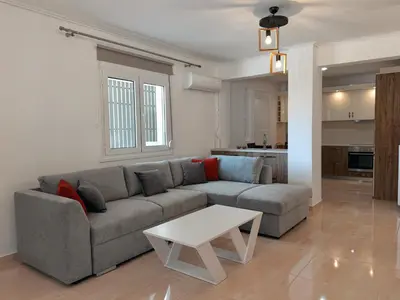 a living room with a couch and a table at Seaview Complex with Pool in Porto Rafti