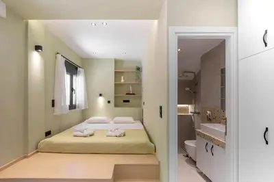 a bedroom with a bed and a bathroom at Kais eleven studio in Athens