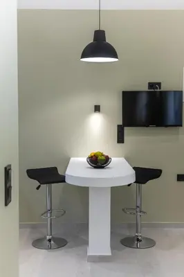 a kitchen with a table with a bowl of fruit on it at Kais eleven studio in Athens