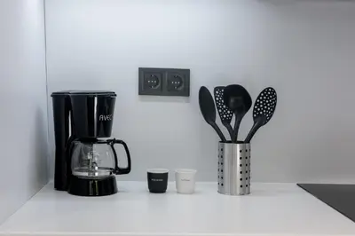 a kitchen counter with a coffee maker and utensils at Kais eleven studio in Athens