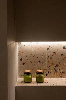 two green jars sitting on a ledge with a rock wall at Kais eleven studio in Athens