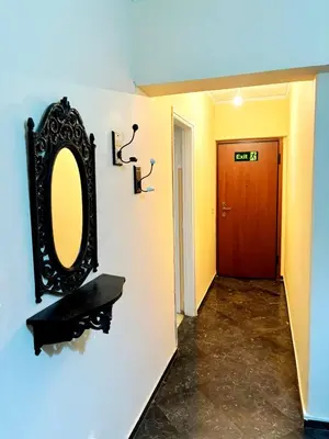a mirror on a wall next to a hallway at Imperial 2 in Athens