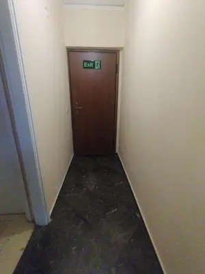 a hallway with a door with a sign on it at Imperial 2 in Athens