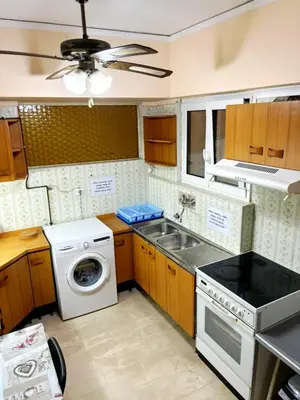 a kitchen with a sink and a washing machine at Imperial 2 in Athens