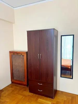 a large wooden cabinet in a room with a mirror at Imperial 2 in Athens