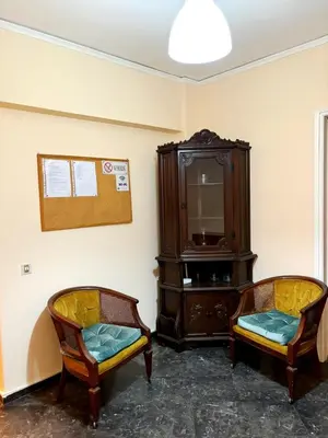 a living room with two chairs and a cabinet at Imperial 2 in Athens