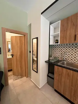 a kitchen with a sink and a mirror at Panathenaic Stadium area Model Cozy Studio B in Athens