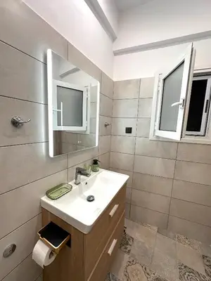 a bathroom with a sink and a mirror at Panathenaic Stadium area Model Cozy Studio B in Athens
