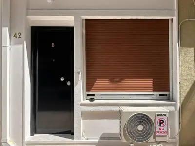 a window with a heater and a window with a blind at Panathenaic Stadium area Model Cozy Studio B in Athens
