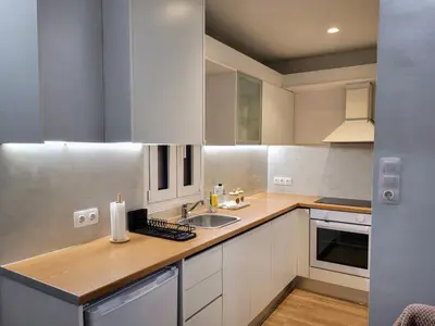 a kitchen with white cabinets and a sink at Athens Pearl in Athens
