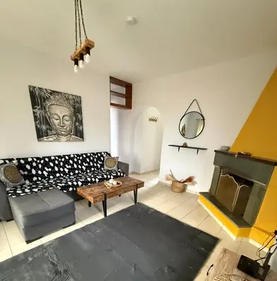 a living room with a couch and a fireplace at Eleni's Seaview House in Saronida