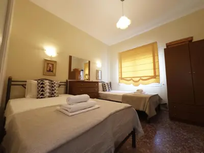a bedroom with two beds with towels on them at Chara's Luxury Home in Vravrona