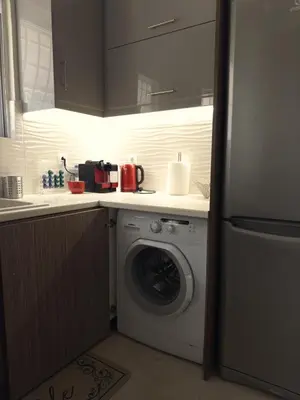 a kitchen with a washing machine and a sink at Chara's Luxury Home in Vravrona