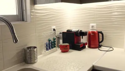 a kitchen counter with a coffee maker on it at Chara's Luxury Home in Vravrona