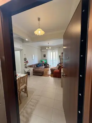 a living room with a door open to a living room at A nest for two in Athens in Mesochórion