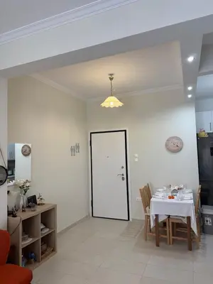 a dining room with a table and a white door at A nest for two in Athens in Mesochórion