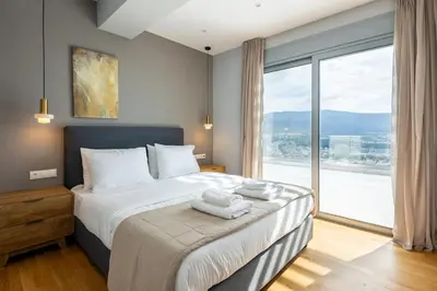 a bedroom with a large bed with a large window at Athens Sky Loft in Athens