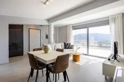 a living room with a table and a couch at Athens Sky Loft in Athens