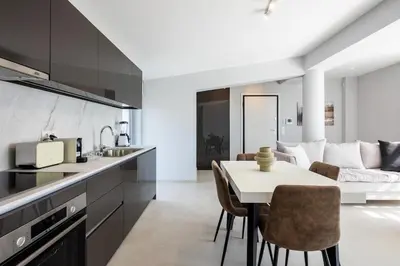 a kitchen and living room with a table and chairs at Athens Sky Loft in Athens