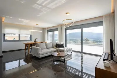 a living room with a couch and a table at City Lights Residence Psyxiko in Athens