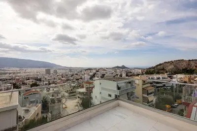 a view of a city from the roof of a building at City Lights Residence Psyxiko in Athens