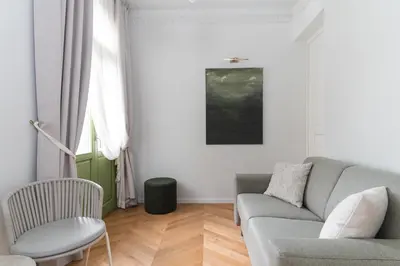 a living room with a couch and a chair at Ogigou Suites in Athens