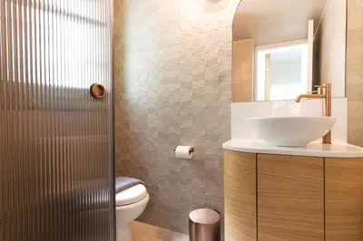 a bathroom with a sink and a toilet at Ogigou Suites in Athens