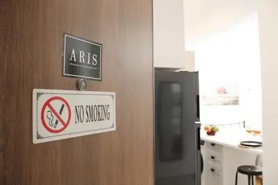 a sign on a door with a no smoking sign on it at ARIS Urban Exarchia in Athens
