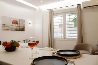 a table with two plates and a glass of wine at ARIS Urban Exarchia in Athens