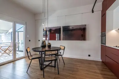 a kitchen and dining room with a table and chairs at Athenian Sky, Two Bedroom Apartment in Koukaki in Athens