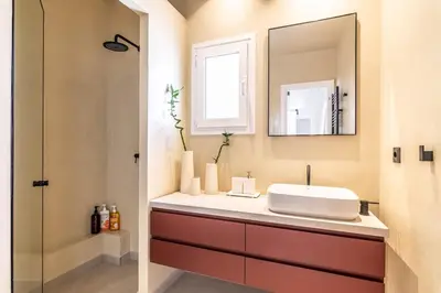 a bathroom with a sink and a mirror at Athenian Sky, Two Bedroom Apartment in Koukaki in Athens