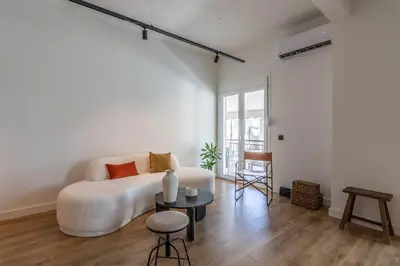 a living room with a white couch and a table at Athenian Sky, Two Bedroom Apartment in Koukaki in Athens