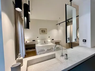 a bathroom with a sink and a bed in a room at Chic Central Gem Walk to Acropolis in 10 minutes in Athens