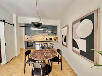 a kitchen and dining room with a table and chairs at Chic Central Gem Walk to Acropolis in 10 minutes in Athens