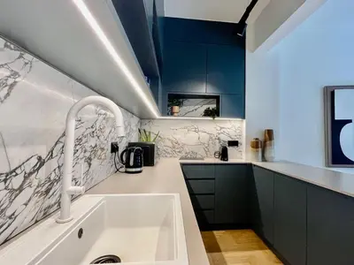 a kitchen with a white sink and blue cabinets at Chic Central Gem Walk to Acropolis in 10 minutes in Athens