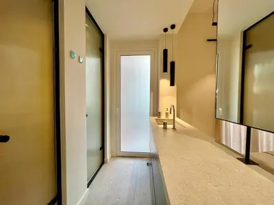 a hallway with a door leading to a bathroom at Chic Central Gem Walk to Acropolis in 10 minutes in Athens