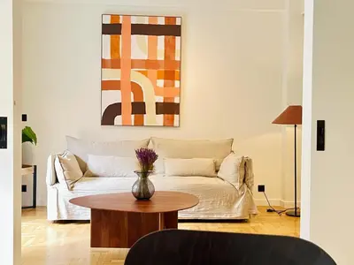 a living room with a couch and a table at Chic Central Gem Walk to Acropolis in 10 minutes in Athens