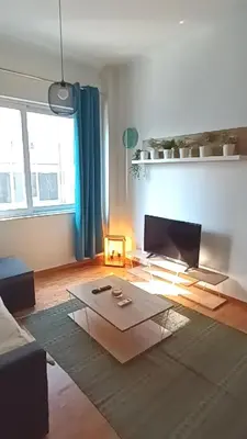 a living room with a couch and a table at Argy's cozy apartment in Pireaus Port in Piraeus