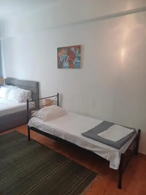 a bedroom with a bed and a painting on the wall at Argy's cozy apartment in Pireaus Port in Piraeus