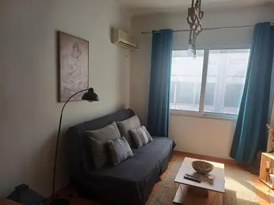 a living room with a couch and a table at Argy's cozy apartment in Pireaus Port in Piraeus