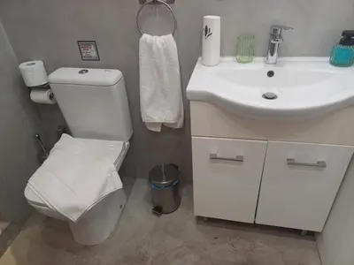 a bathroom with a white toilet and a sink at Argy's cozy apartment in Pireaus Port in Piraeus