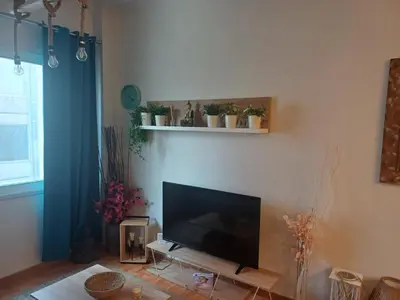 a living room with a flat screen tv on a wall at Argy's cozy apartment in Pireaus Port in Piraeus