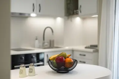 a bowl of fruit on a counter in a kitchen at Kais 1st floor studio in Athens