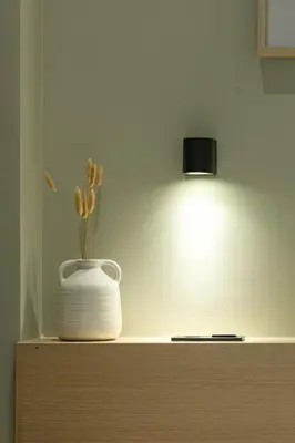 a white vase sitting on top of a dresser with a light at Kais 1st floor studio in Athens