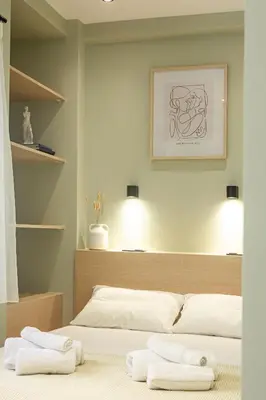 a bedroom with two white towels on a bed at Kais 1st floor studio in Athens