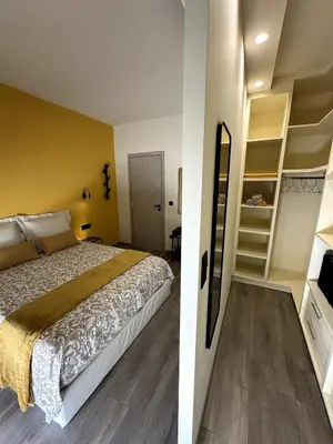 two images of a bedroom with a bed and a tv at Her Luxury Apartment in Athens