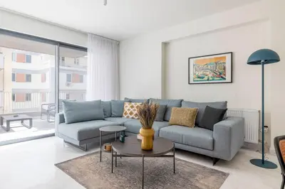 a living room with a couch and a table at The HostMaster WiseView Azure in Athens