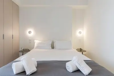 a bedroom with a large white bed with two pillows at The HostMaster WiseView Azure in Athens