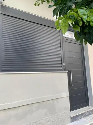 a pair of garage doors on a building at The Athenian Filo by Mountain Hotels in Athens