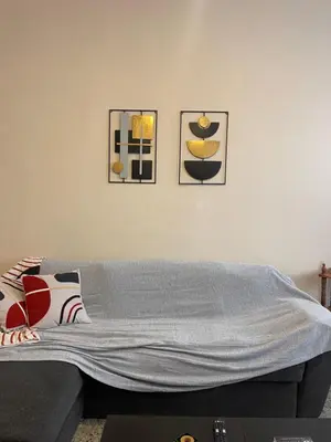 a living room with a couch and three pictures on the wall at The Athenian Filo by Mountain Hotels in Athens